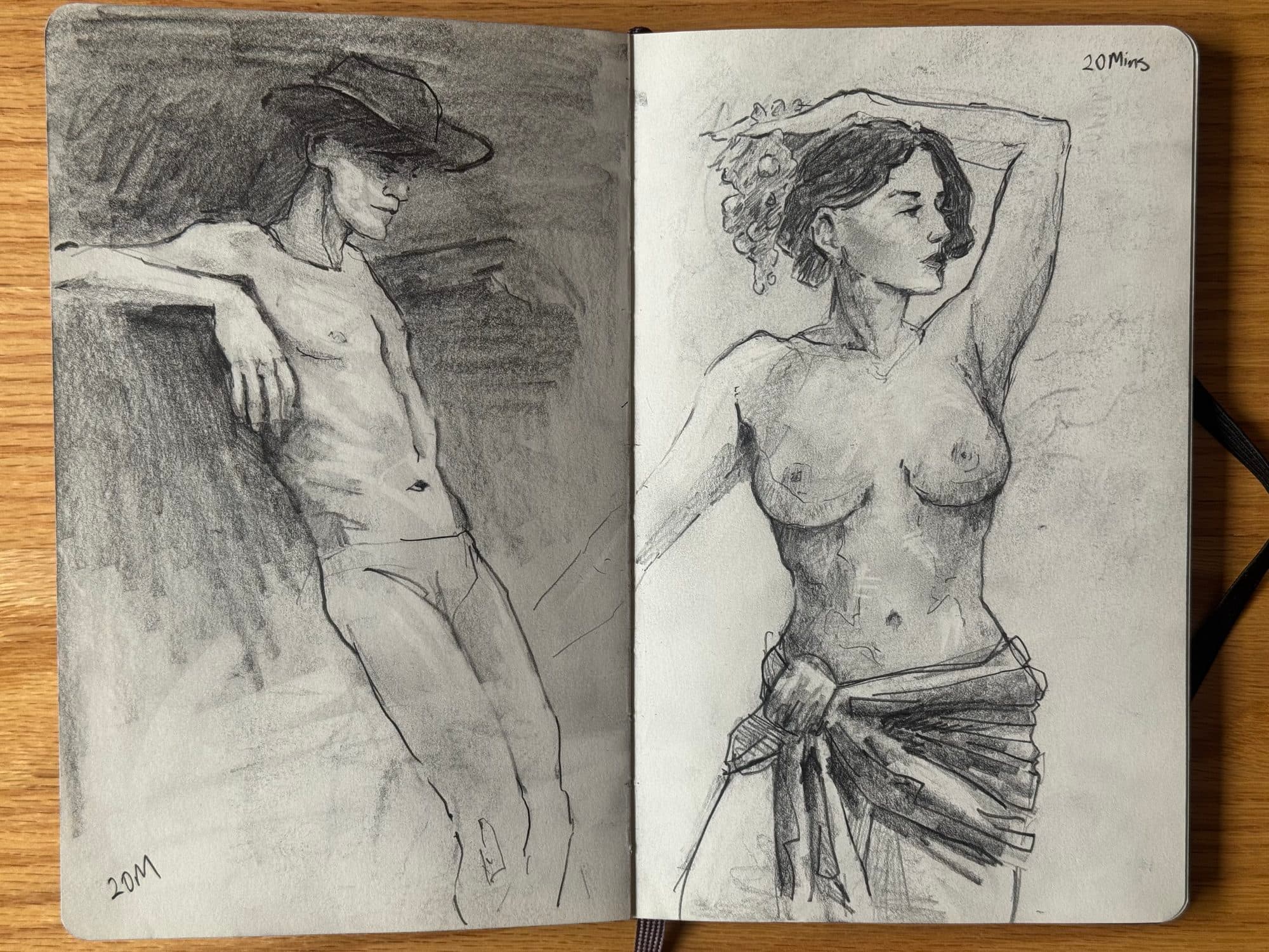 Sketchbook spread of two twenty-minute graphite figure drawings: a shirtless man in a cowboy hat leaning on a wall and a topless woman with a wrap at her hips.