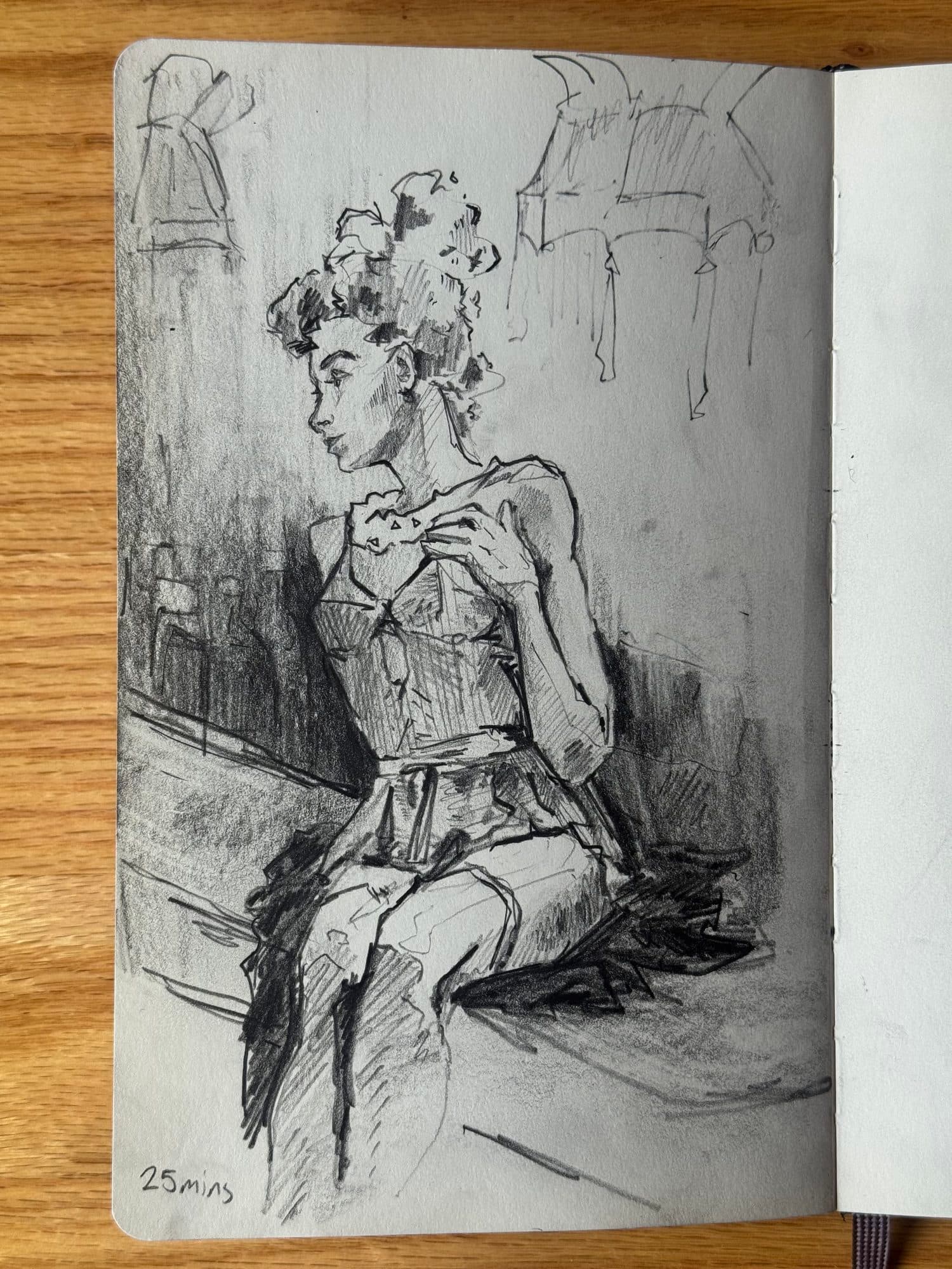 Twenty-five-minute graphite drawing of a seated woman with curly updo, in a corset and tulle skirt, glancing to the side.