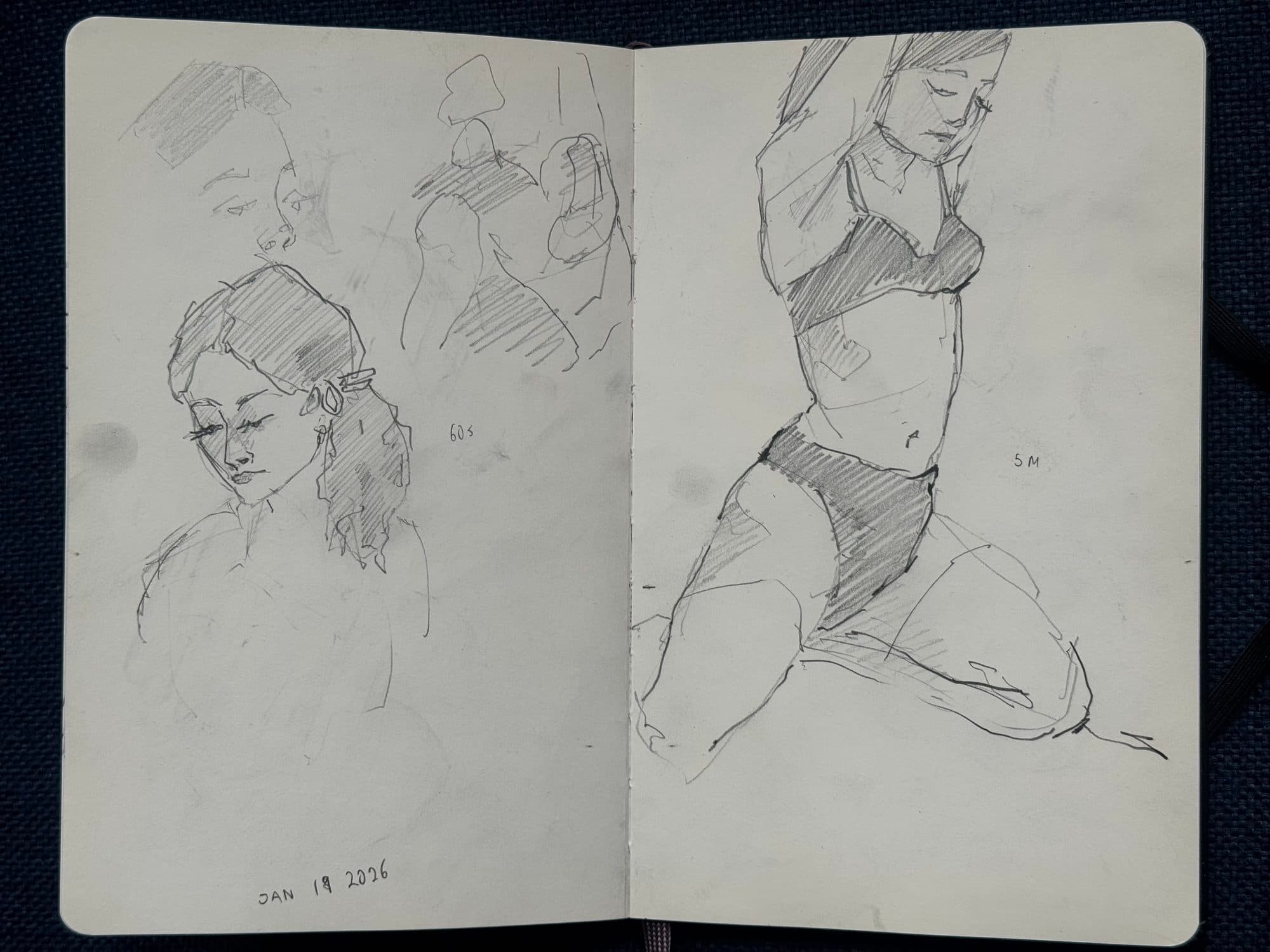 Sketchbook spread of quick graphite gesture studies of a model, including a portrait with earrings and a kneeling pose with arms raised.
